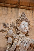 Chiang Mai - The Wat Phra Singh temple. The ho trai (temple library). The stucco figures in high relief of the base showing dancing Devas. 